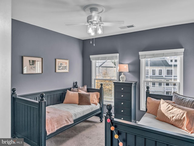 bedroom with ceiling fan and carpet floors