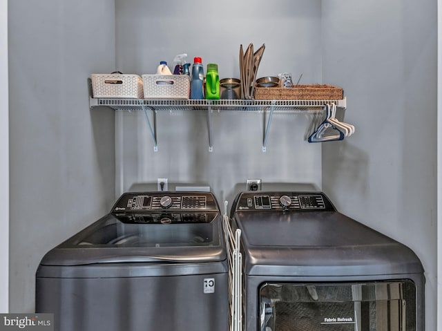 laundry area featuring washing machine and clothes dryer