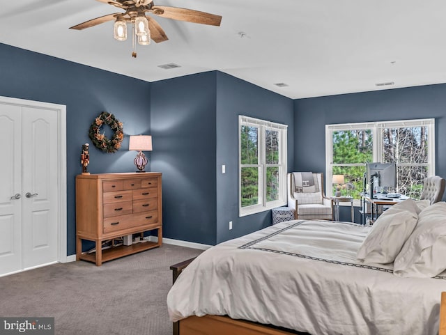 carpeted bedroom with ceiling fan and a closet