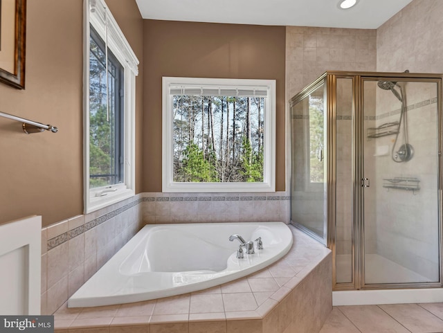 bathroom with tile patterned flooring, a wealth of natural light, and independent shower and bath