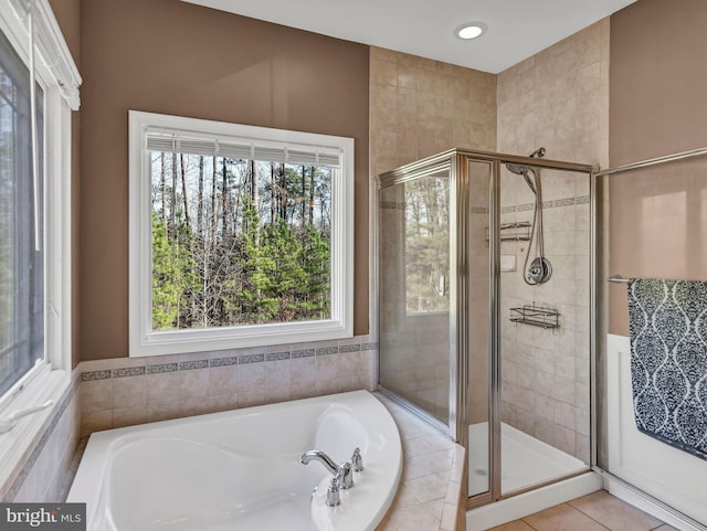 bathroom featuring tile patterned flooring and separate shower and tub