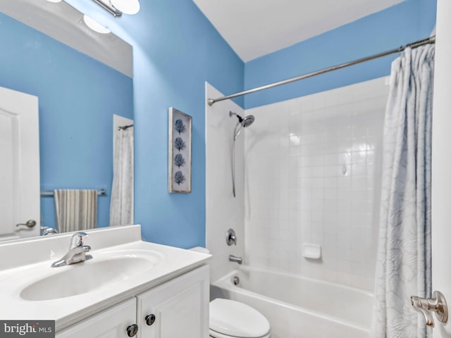 full bathroom with vanity, shower / tub combo, and toilet