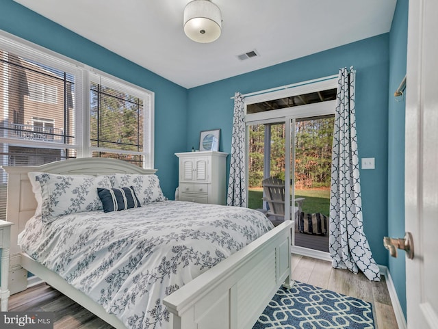 bedroom featuring access to exterior and light wood-type flooring