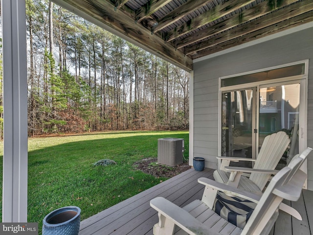 deck with a lawn and central air condition unit