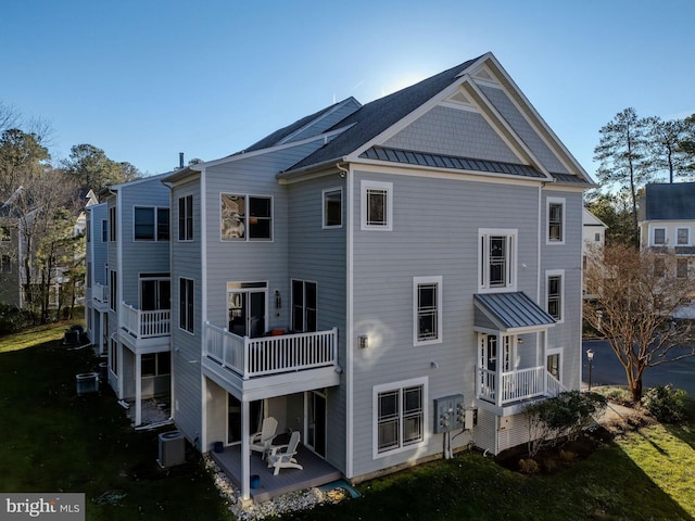 back of property featuring central AC unit