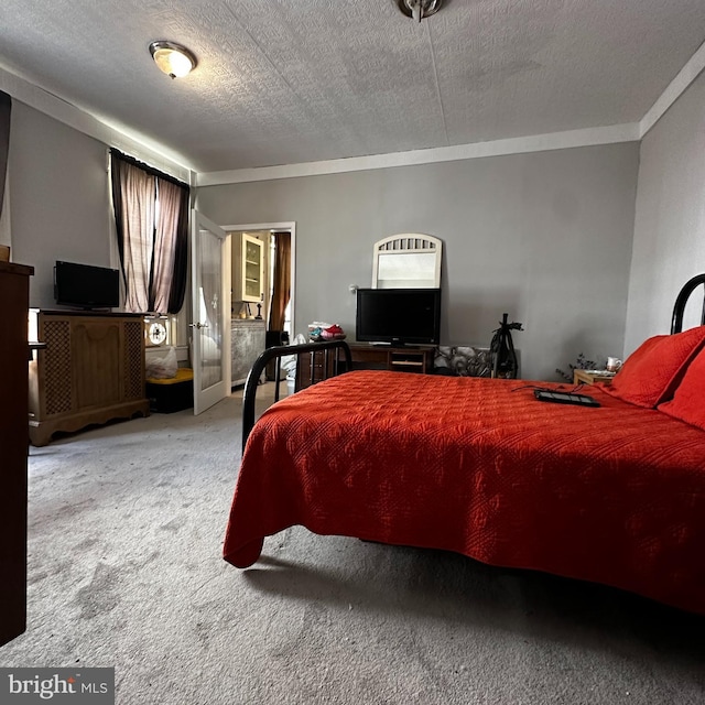 carpeted bedroom featuring a textured ceiling and ornamental molding