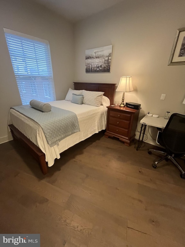 bedroom with hardwood / wood-style flooring