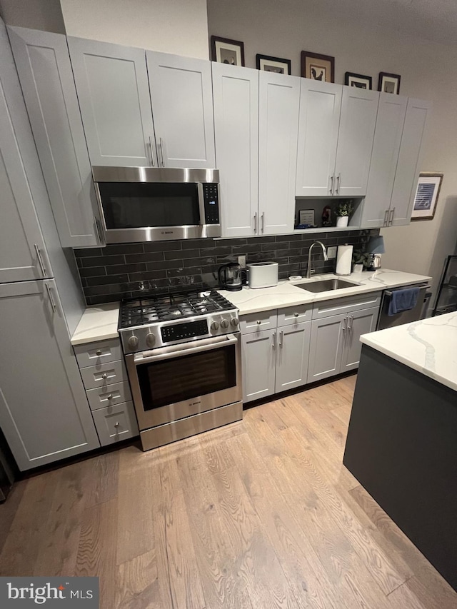 kitchen featuring sink, light wood-type flooring, and stainless steel appliances