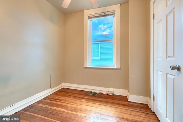 spare room featuring wood-type flooring and ceiling fan