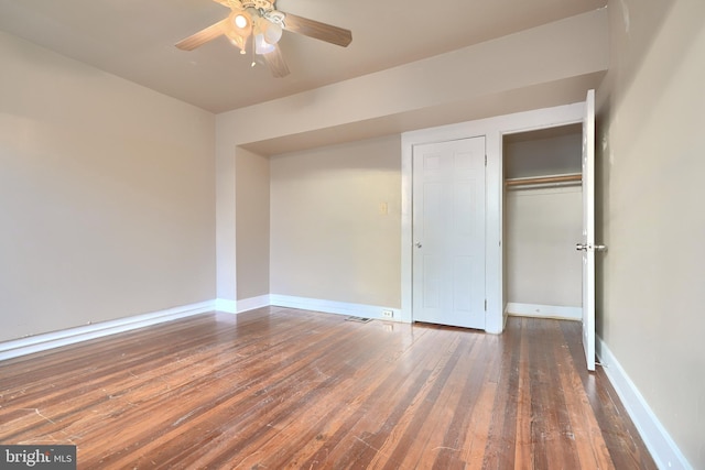 unfurnished bedroom featuring a closet, dark hardwood / wood-style floors, and ceiling fan