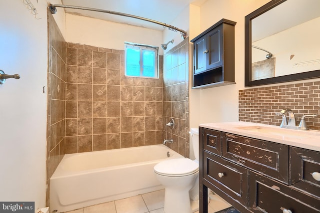 full bathroom with vanity, tiled shower / bath, tile patterned flooring, toilet, and tasteful backsplash