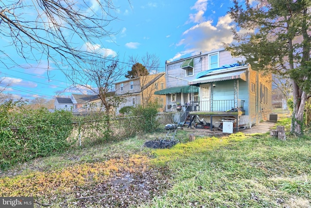 rear view of property featuring central AC