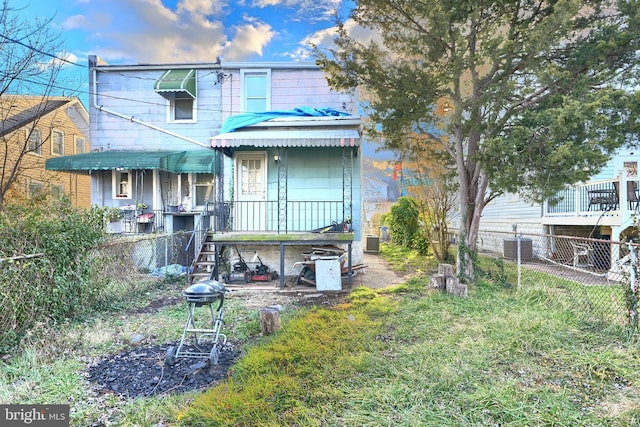 rear view of property featuring cooling unit