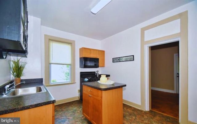 kitchen with sink, a center island, and range