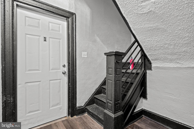 staircase with hardwood / wood-style floors