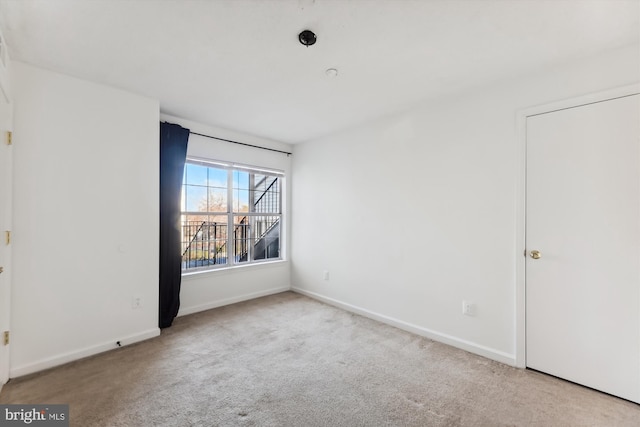 empty room featuring light colored carpet