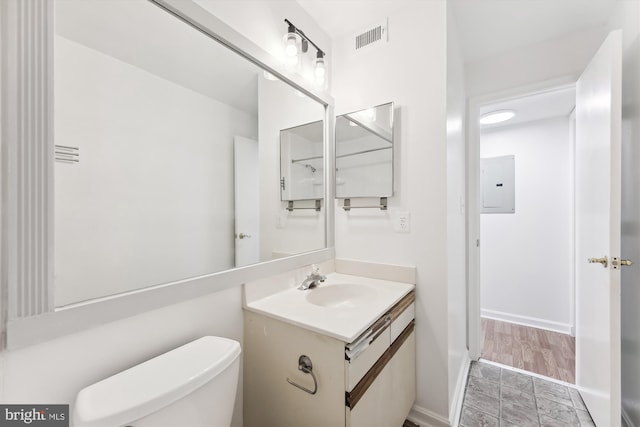 bathroom with vanity, electric panel, and toilet