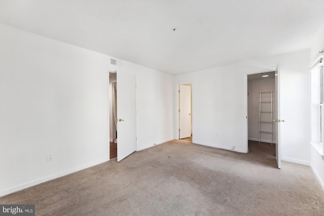 unfurnished bedroom featuring light carpet