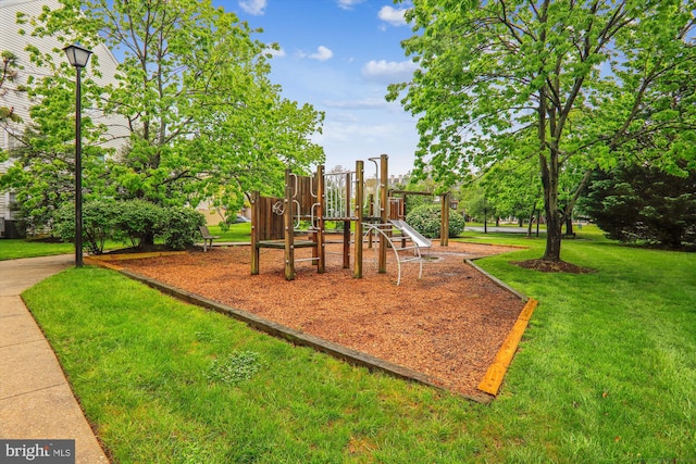 view of playground with a lawn