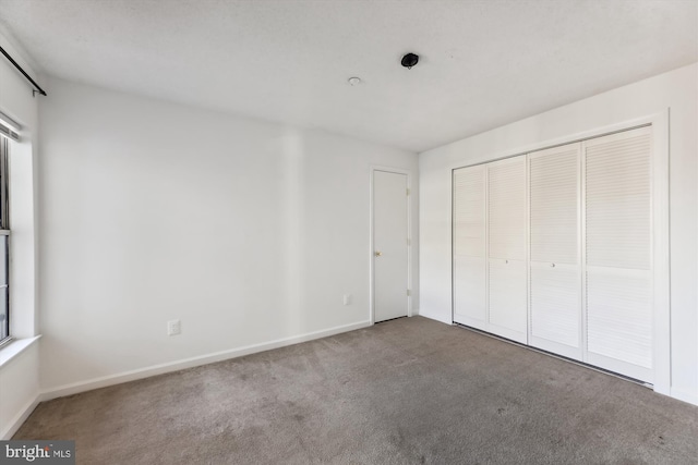 unfurnished bedroom with carpet and a closet