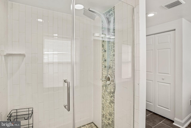 bathroom featuring tile patterned flooring and a shower with door