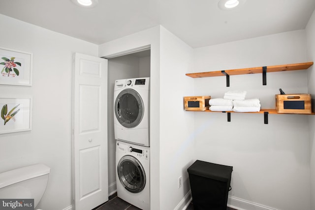 laundry area with stacked washer / drying machine