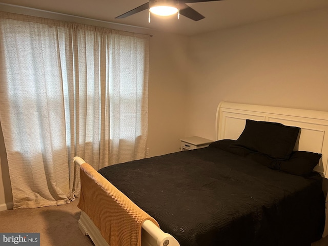 bedroom with ceiling fan and carpet floors