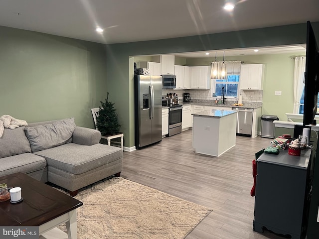 living room featuring light wood-type flooring and sink