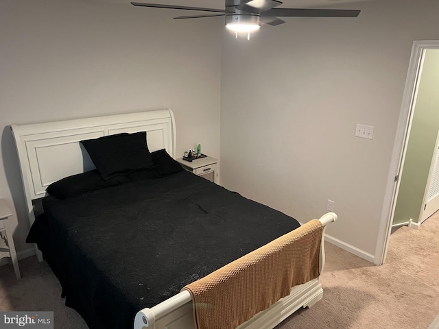 bedroom with ceiling fan and light carpet