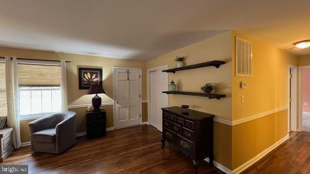 sitting room with dark hardwood / wood-style flooring