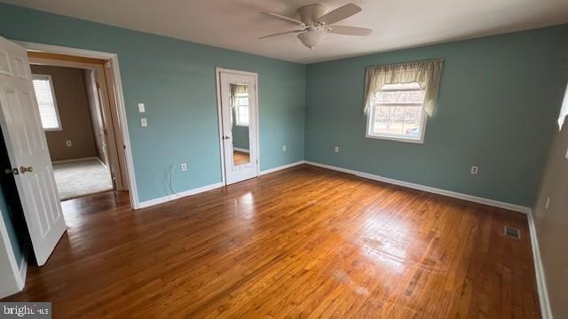 unfurnished bedroom featuring ceiling fan and hardwood / wood-style flooring