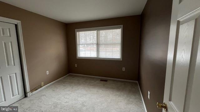 unfurnished bedroom featuring light carpet