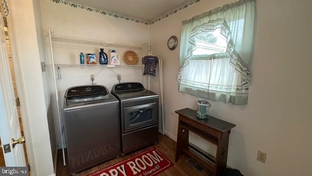 washroom featuring dark hardwood / wood-style floors and separate washer and dryer