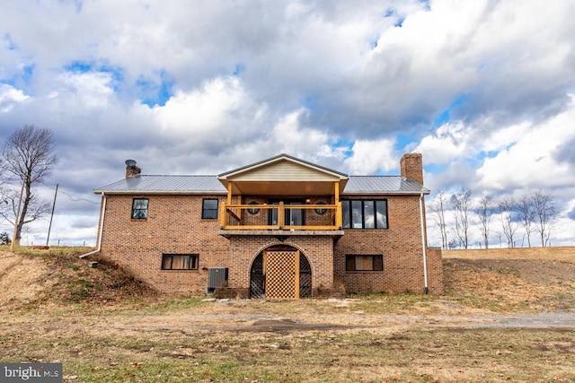 2520 Ridge Rd, Upper Tract, WV 26866 - back of property with a chimney, brick siding, and a metal roof