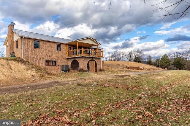 2520 Ridge Rd, Upper Tract, WV 26866 - rear view of house featuring brick siding, a chimney, a metal roof, a wooden deck, and a yard