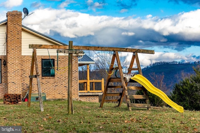 view of jungle gym featuring a lawn