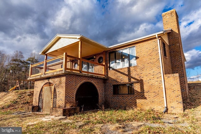 2520 Ridge Rd, Upper Tract, WV 26866 - view of home's exterior with a chimney, brick siding, and a balcony