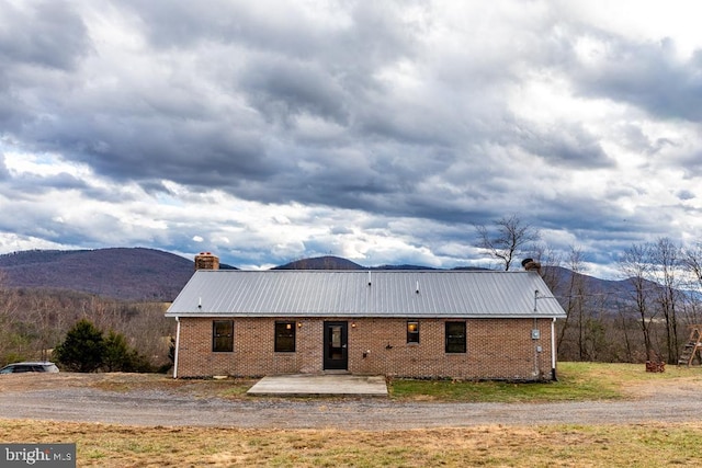 rear view of house with a mountain view