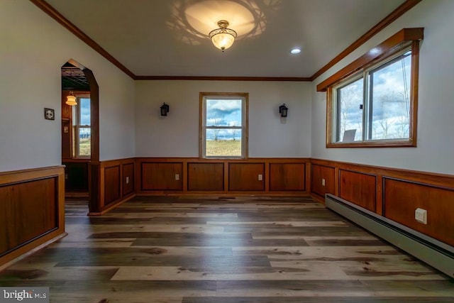 2520 Ridge Rd, Upper Tract, WV 26866 - unfurnished dining area with baseboard heating, wood finished floors, a wainscoted wall, arched walkways, and ornamental molding