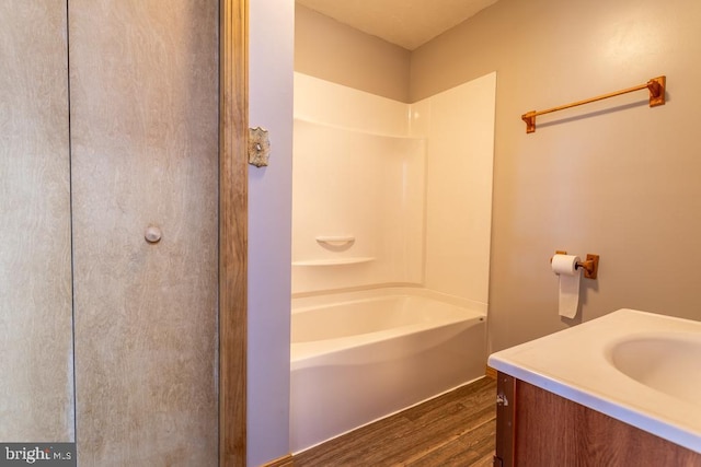 bathroom with vanity, wood-type flooring, and bathing tub / shower combination