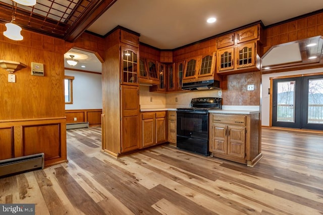 2520 Ridge Rd, Upper Tract, WV 26866 - kitchen with black range with electric cooktop, crown molding, under cabinet range hood, brown cabinets, and a baseboard heating unit
