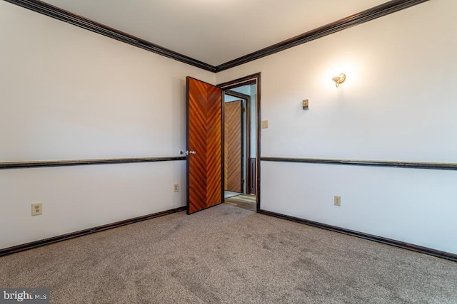 spare room with crown molding and light colored carpet