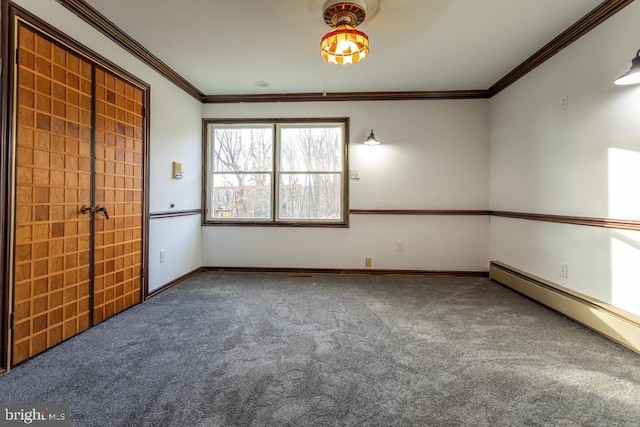 empty room with carpet, crown molding, and a baseboard heating unit