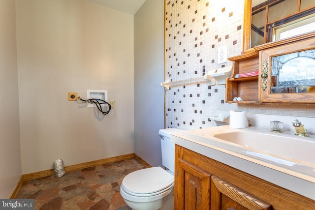 bathroom featuring backsplash, vanity, and toilet