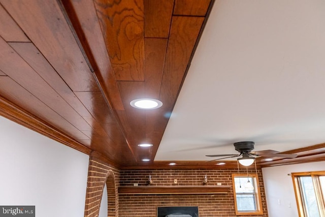 room details with ornamental molding, ceiling fan, and wooden ceiling