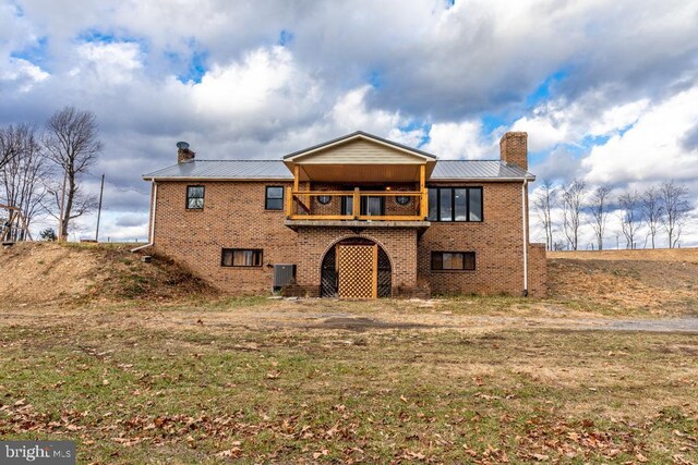 2520 Ridge Rd, Upper Tract, WV 26866 - rear view of house featuring a chimney, brick siding, a balcony, and a metal roof