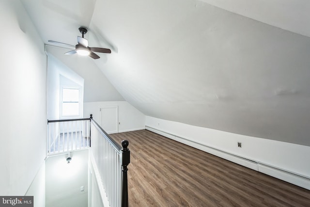 additional living space featuring ceiling fan, a baseboard radiator, vaulted ceiling, and hardwood / wood-style flooring