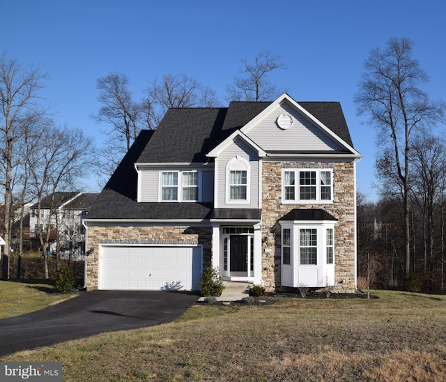 view of front of home featuring a front yard and a garage