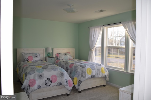 bedroom with multiple windows and carpet