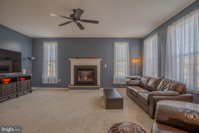 carpeted living room with ceiling fan